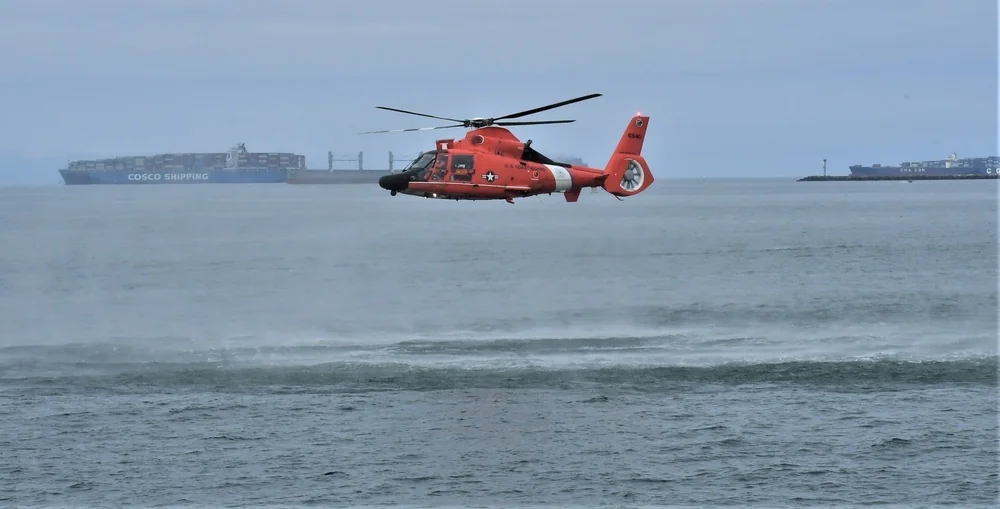 MH-65 Dolphin hovering over the sea during training